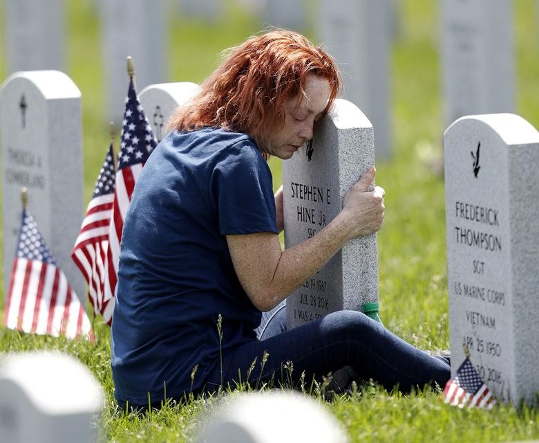 Maria Velez of Orlando, Florida, hugs the tombstone of her son Stephen at the Ohio Western Reserve National Cemetery on Memorial Day in Seville, Ohio. REUTERS/Aaron Josefczyk